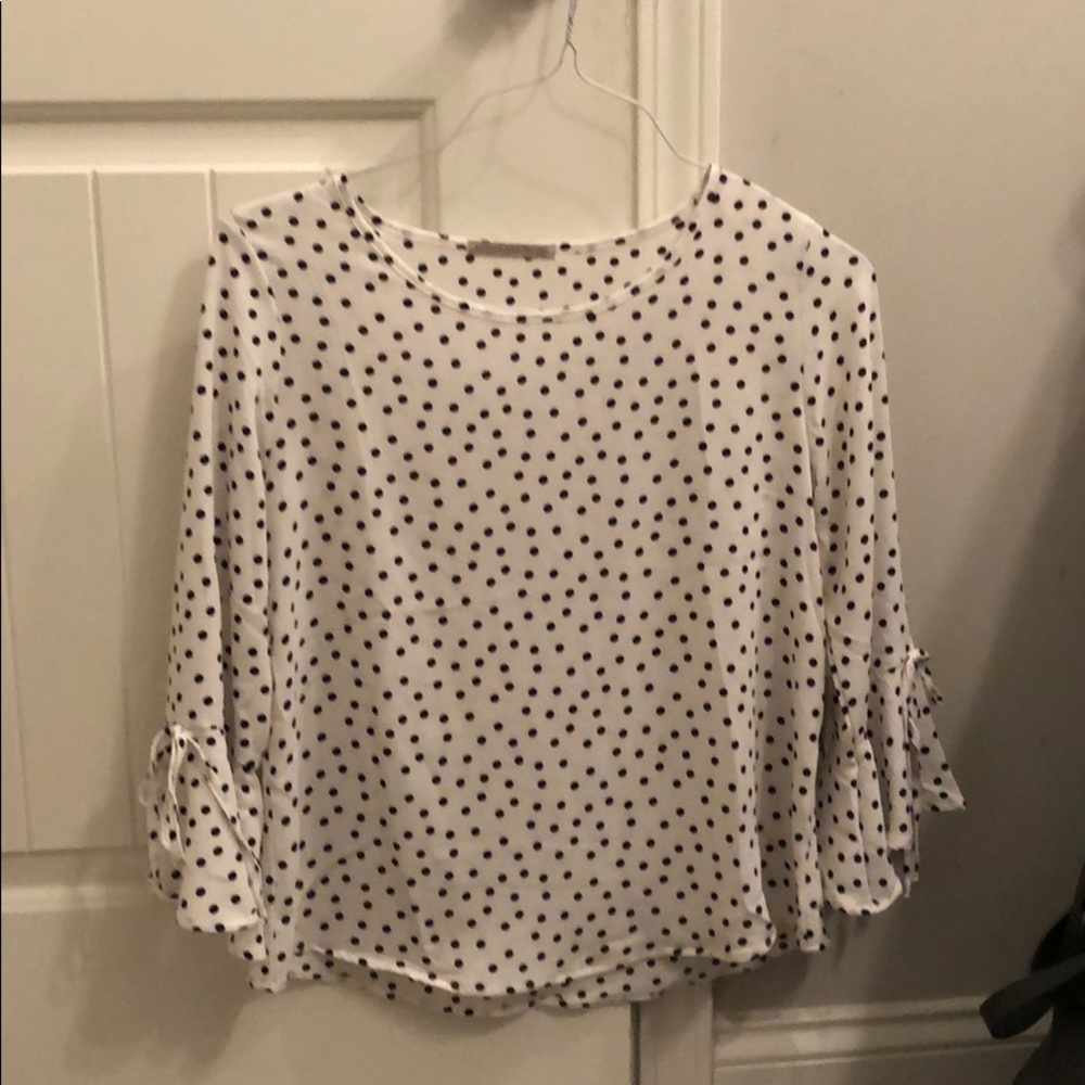 White and black polka dot blouse.